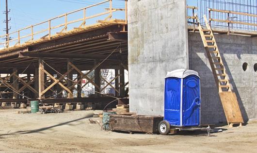 porta potties lined up neatly, ready to serve job site workers